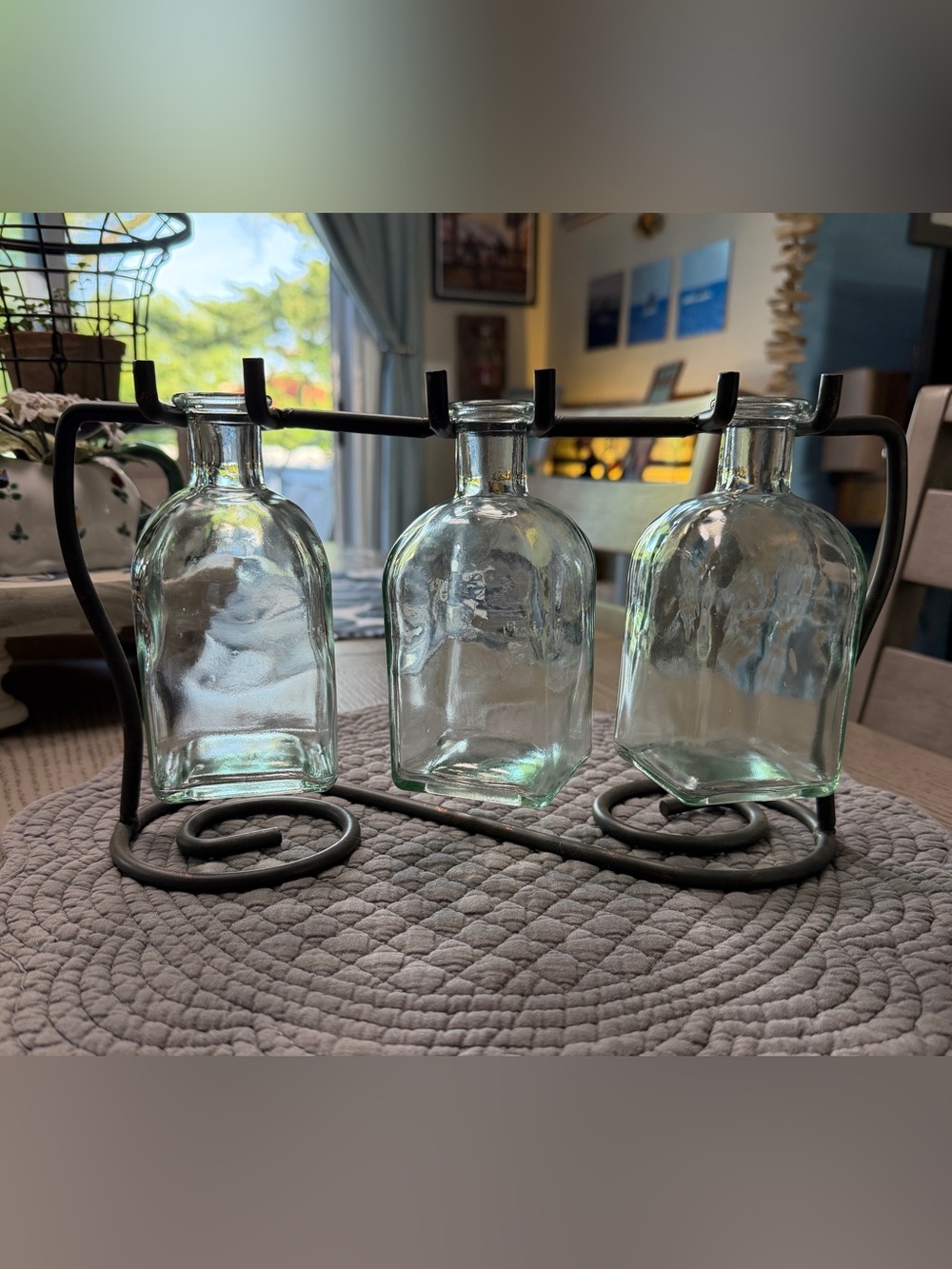 Clear Glass Bottle Trio on Black Metal Stand